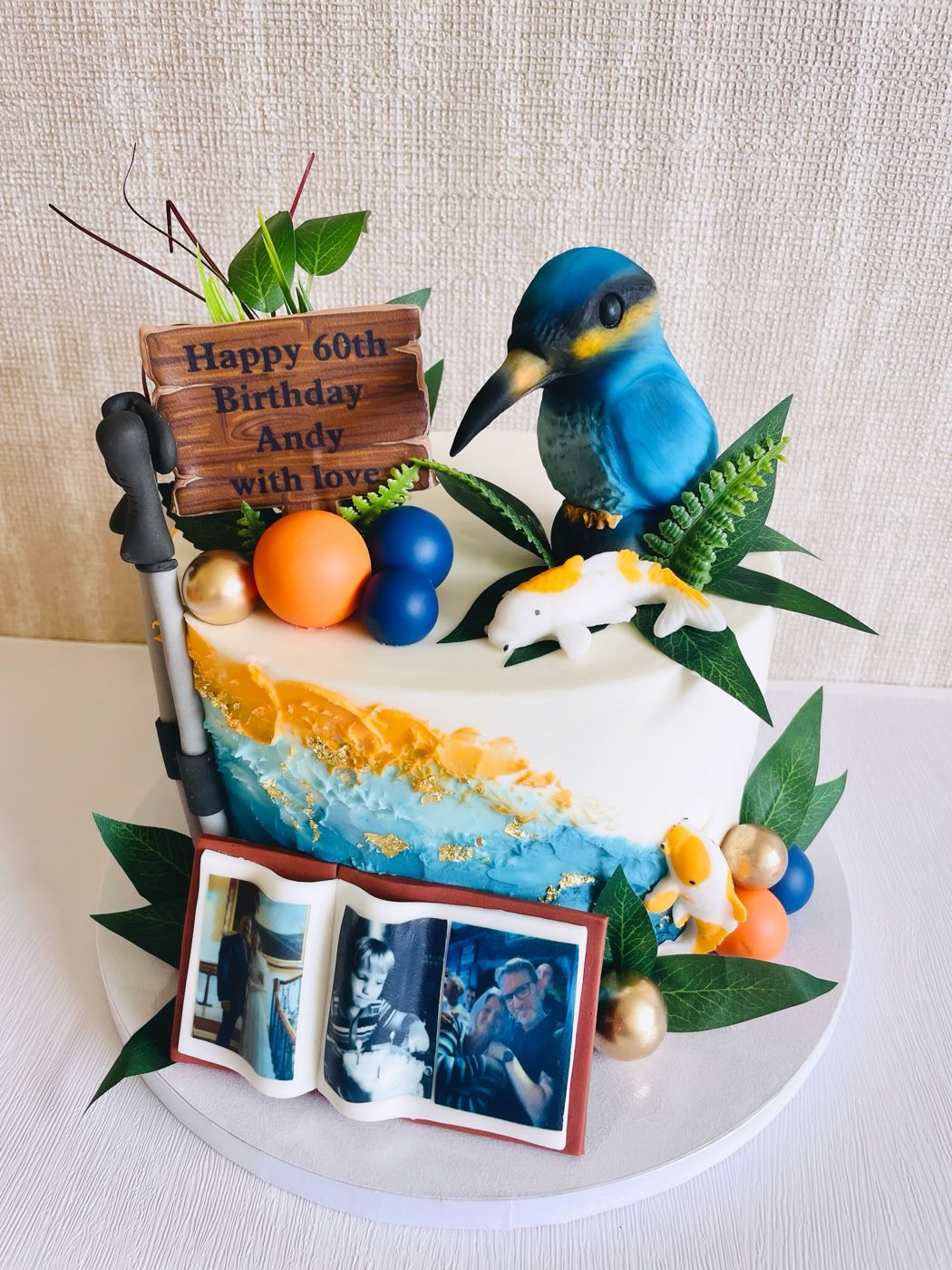 A bespoke 60th birthday cake with a kingfisher and personal touches
