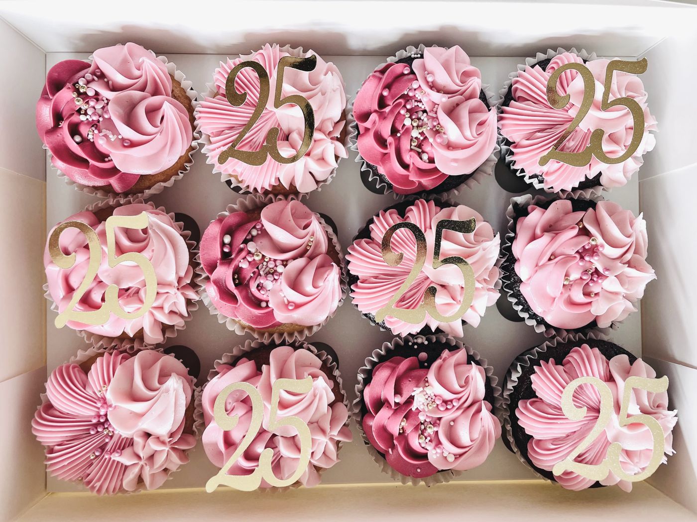 A box of pink swirl birthday cupcakes